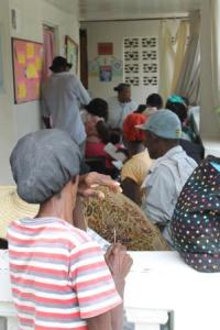 Patients wait on the clinic porch to be seen.